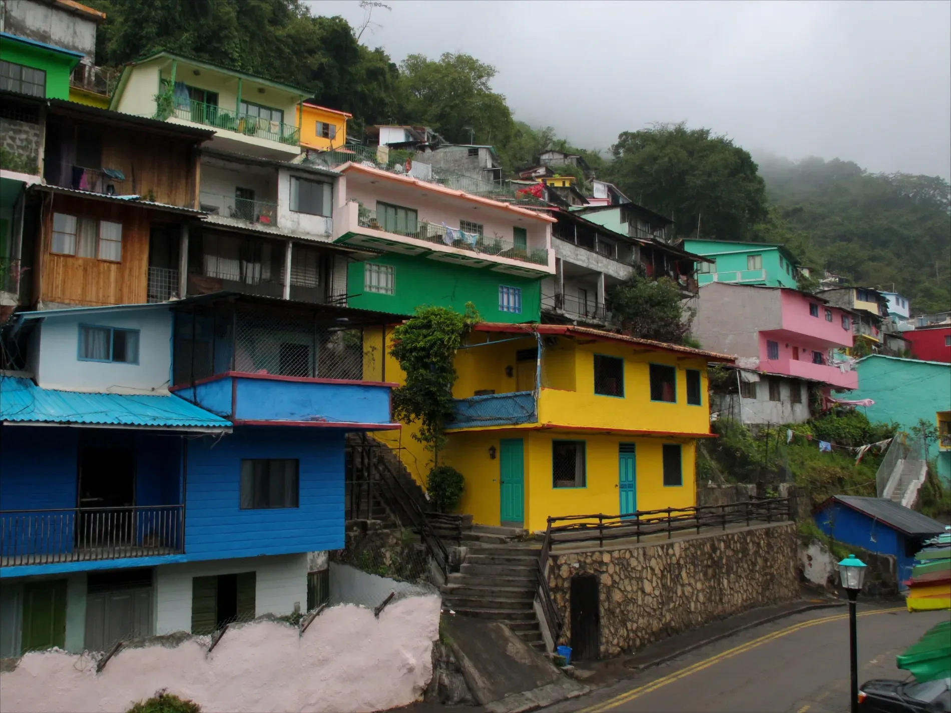 A steep hillside neighbourhood of brightly painted Panamanian houses